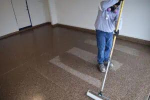 Expert installer applying the final 100%-solids polyaspartic clear coat.